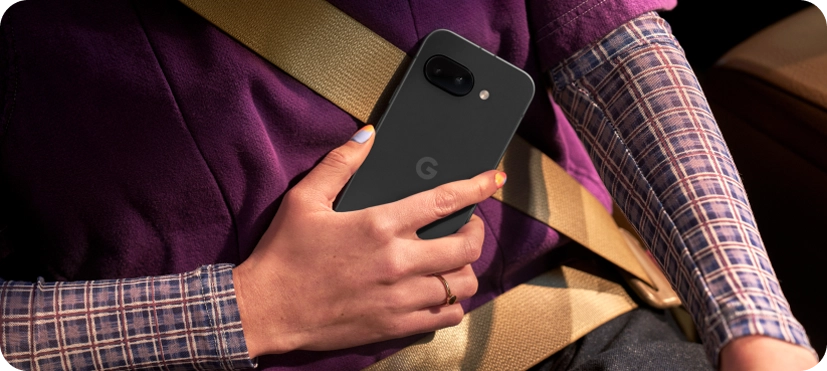 Two friends looking at a Google Pixel 9a