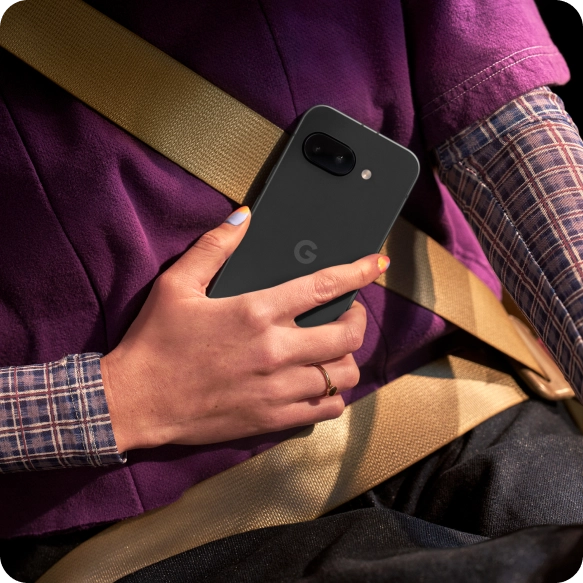 Two friends looking at a Google Pixel 9a