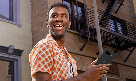 Happy guy holding Google Pixel 9a