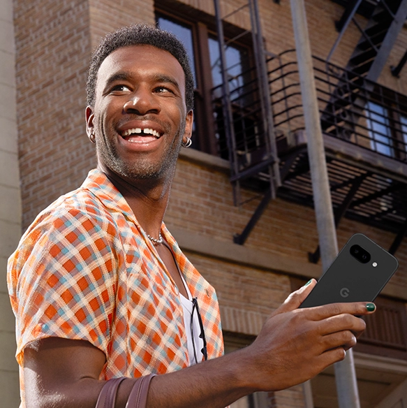 Happy guy holding Google Pixel 9a